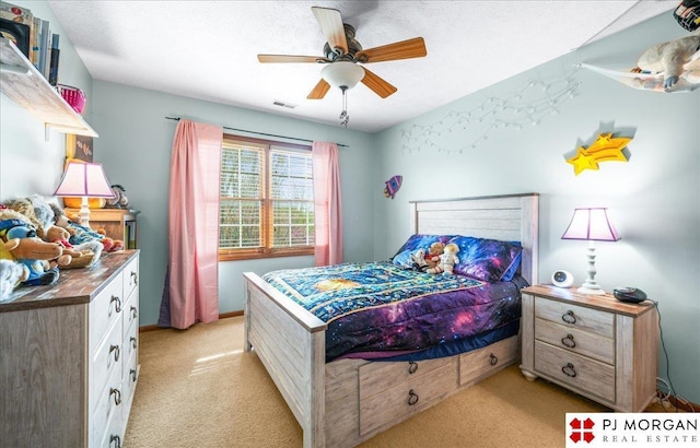 bedroom featuring light colored carpet, visible vents, and a ceiling fan