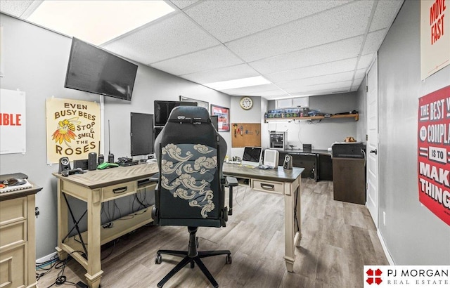 office space featuring wood finished floors and a paneled ceiling
