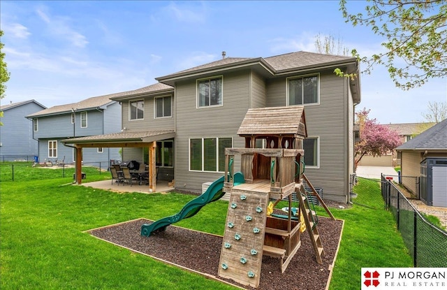 back of property featuring a lawn, a patio, a playground, and a fenced backyard