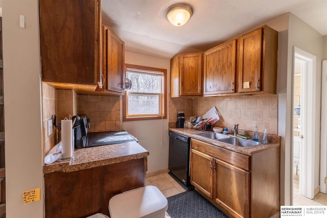 kitchen with decorative backsplash, brown cabinets, dishwasher, a sink, and light tile patterned flooring