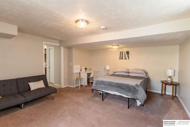bedroom featuring a textured ceiling, carpet, and baseboards