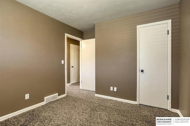 unfurnished bedroom with carpet floors and baseboards