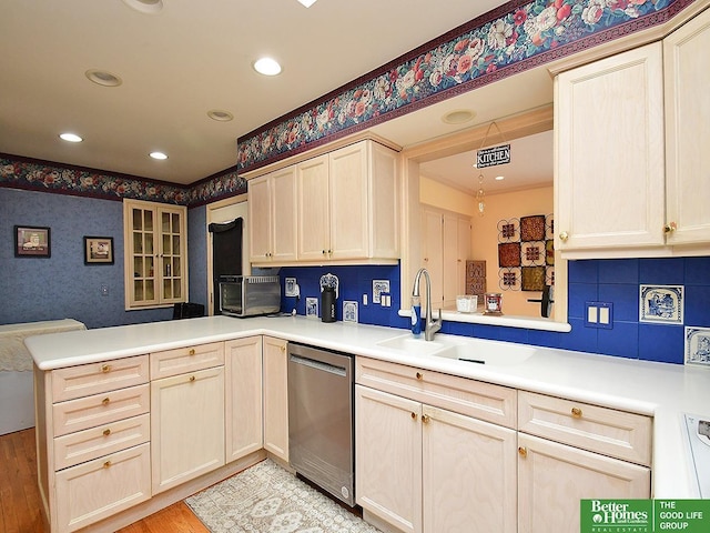600 Ridgewood Ave, Omaha, NE 68114 - kitchen with recessed lighting, stainless steel dishwasher, a peninsula, and a sink