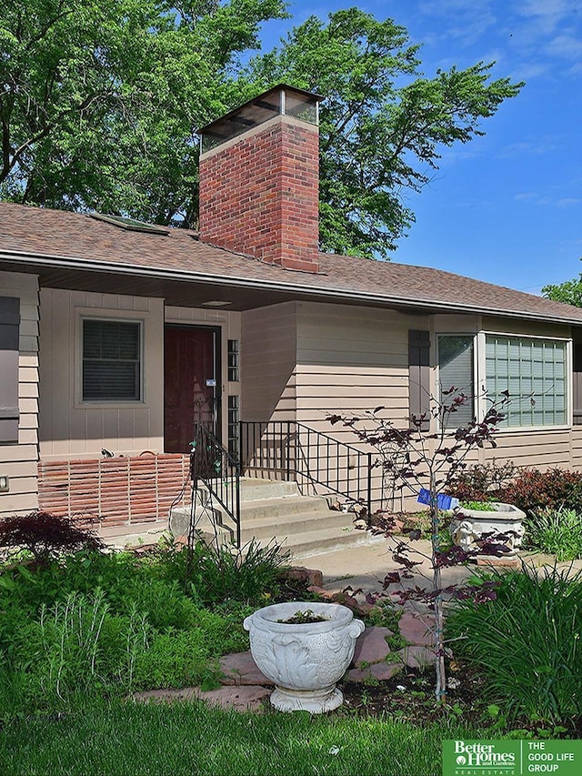 600 Ridgewood Ave, Omaha, NE 68114 - entrance to property featuring a chimney and a shingled roof