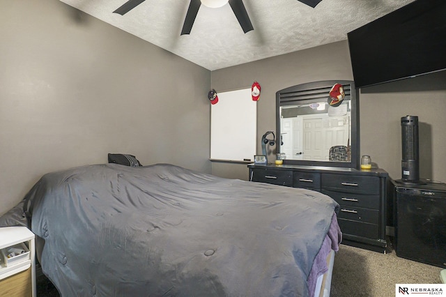 bedroom with a textured ceiling, ceiling fan, and carpet floors
