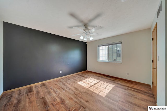 1521 Morton St, Lincoln, NE 68521 - unfurnished room featuring a ceiling fan, wood finished floors, and baseboards