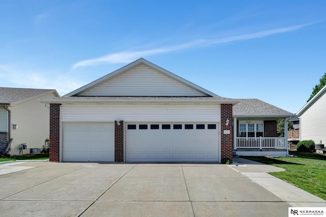 1521 Morton St, Lincoln, NE 68521 - single story home featuring brick siding, driveway, a garage, and a porch