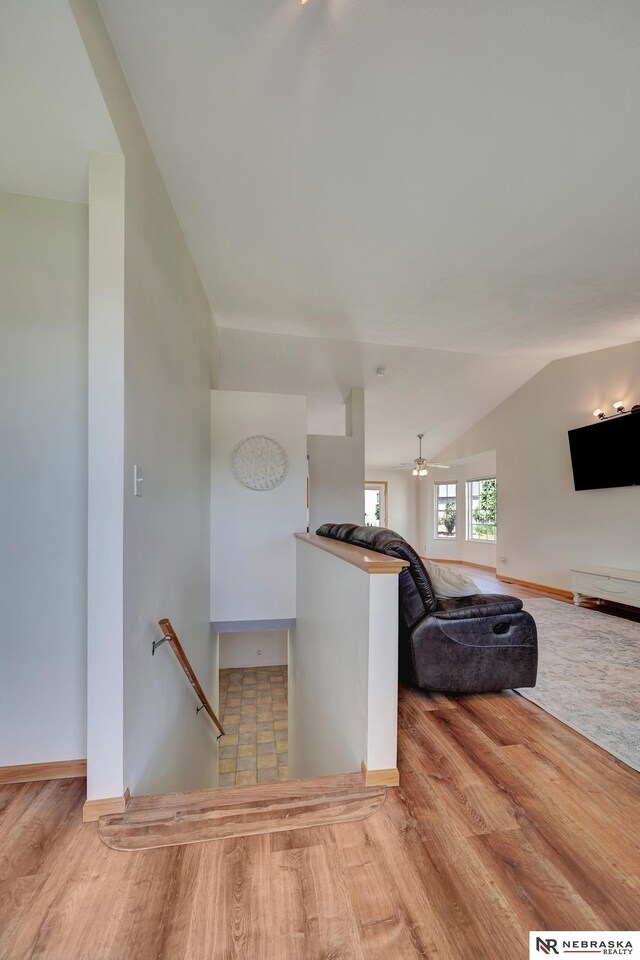 1521 Morton St, Lincoln, NE 68521 - staircase featuring wood finished floors, lofted ceiling, and baseboards