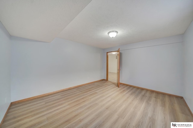 1521 Morton St, Lincoln, NE 68521 - unfurnished bedroom featuring baseboards, light wood finished floors, and a textured ceiling