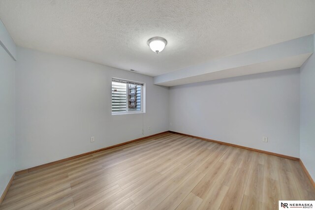 1521 Morton St, Lincoln, NE 68521 - unfurnished room featuring wood finished floors, a textured ceiling, and baseboards