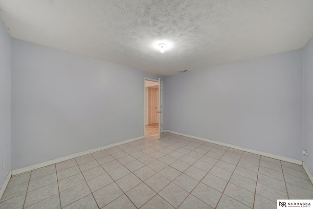 1521 Morton St, Lincoln, NE 68521 - spare room featuring baseboards and a textured ceiling