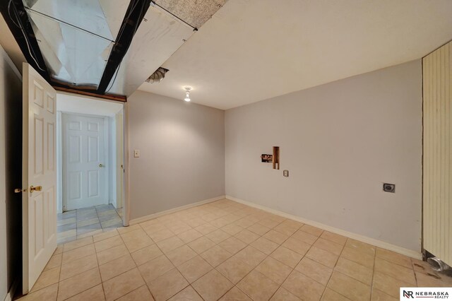1521 Morton St, Lincoln, NE 68521 - unfurnished room with light tile patterned floors and baseboards