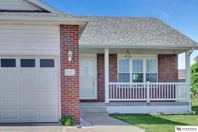 1521 Morton St, Lincoln, NE 68521 - doorway to property featuring an attached garage, covered porch, brick siding, and a shingled roof