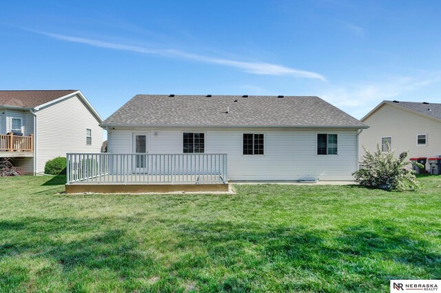 1521 Morton St, Lincoln, NE 68521 - back of property with a wooden deck, a yard, and a shingled roof