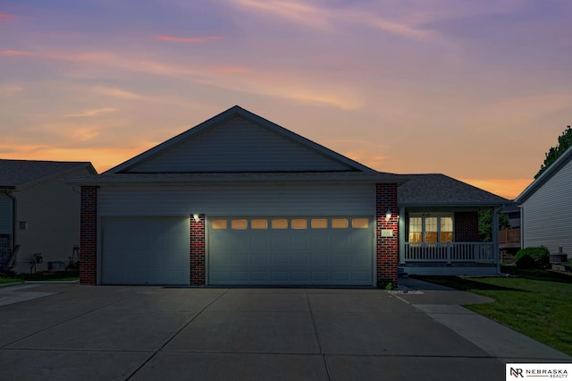 1521 Morton St, Lincoln, NE 68521 - ranch-style home featuring brick siding, driveway, a garage, and covered porch