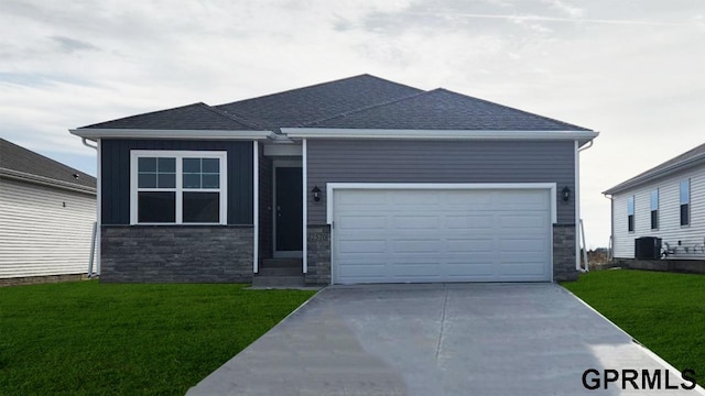 view of front facade featuring a garage, driveway, stone siding, and a front lawn