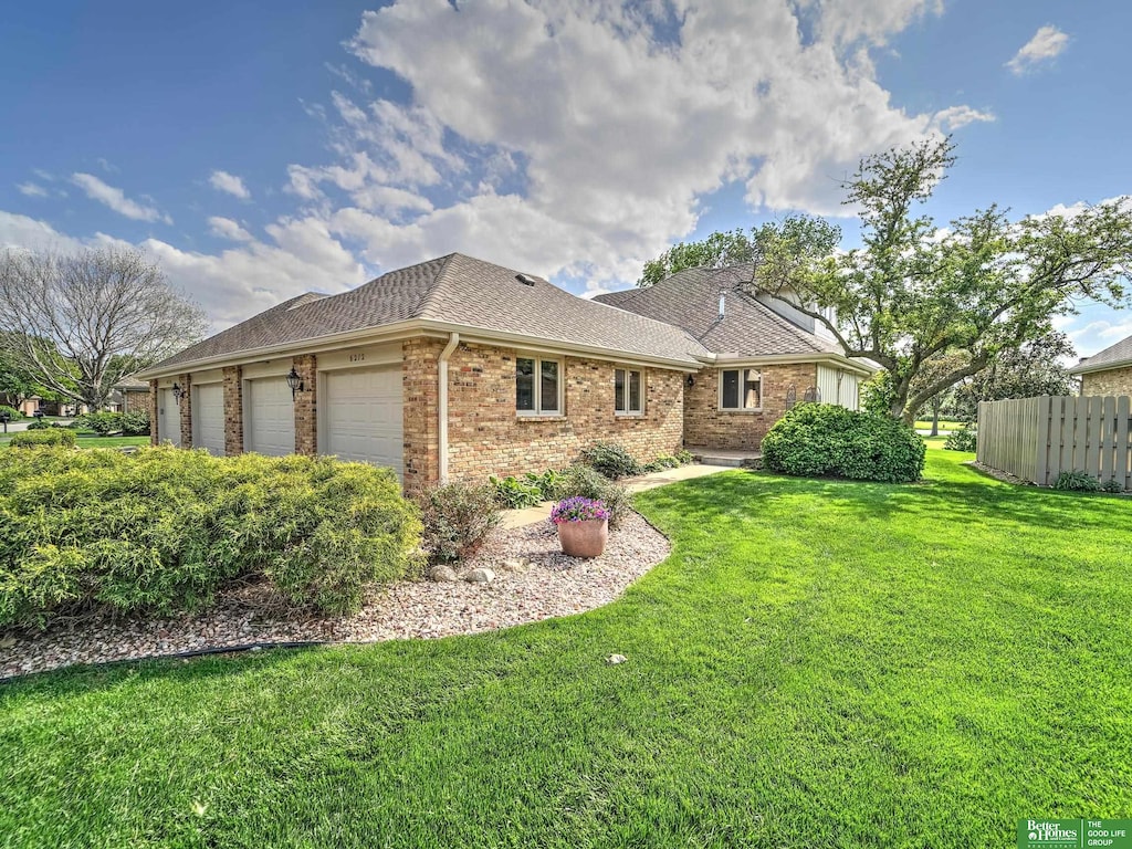6212 Oak Hills Plz, Omaha, NE 68137 - rear view of house featuring brick siding, a garage, and roof with shingles