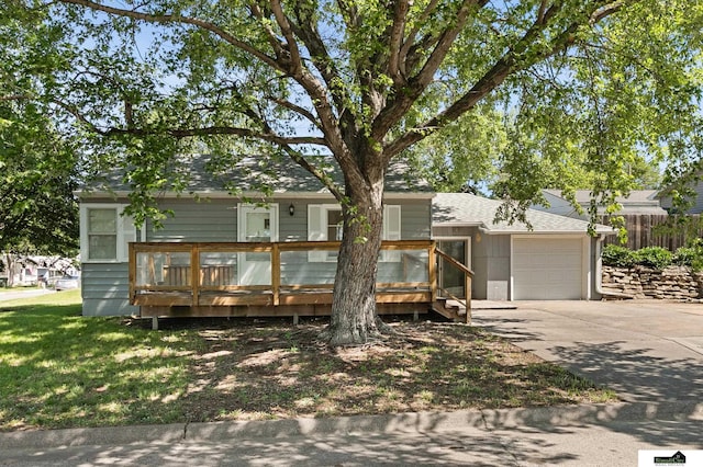 1500 Burnham St, Lincoln, NE 68502 - view of front of property featuring driveway, a garage, and a deck