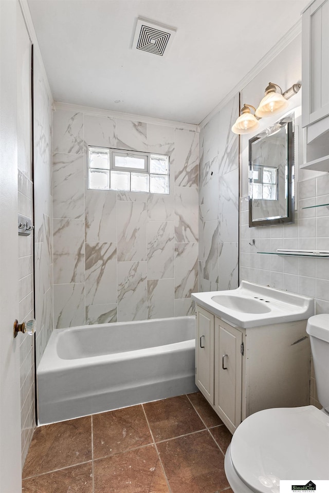 1500 Burnham St, Lincoln, NE 68502 - full bathroom with tile walls, vanity, toilet, and shower / bathtub combination