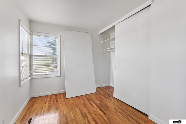 1500 Burnham St, Lincoln, NE 68502 - unfurnished bedroom featuring light wood-style floors, baseboards, and a closet