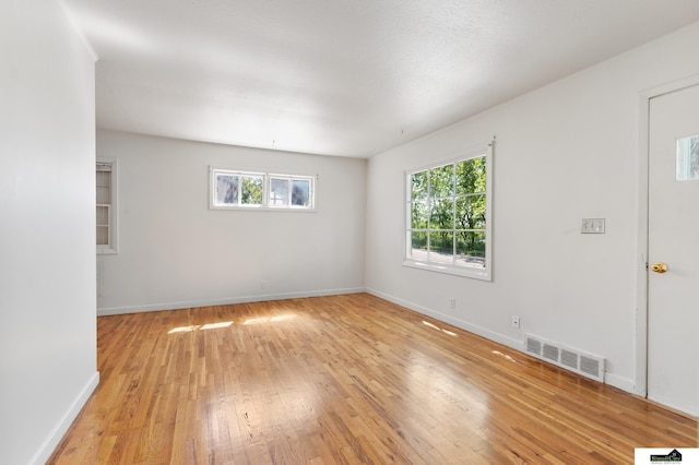 1500 Burnham St, Lincoln, NE 68502 - spare room featuring plenty of natural light, light wood finished floors, and baseboards
