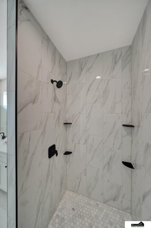 full bath featuring a tile shower