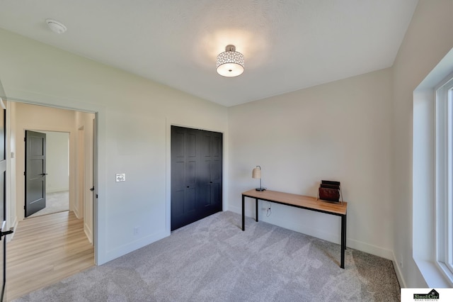unfurnished office with light carpet and baseboards