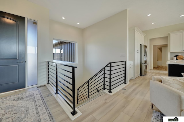 staircase featuring recessed lighting and wood finished floors