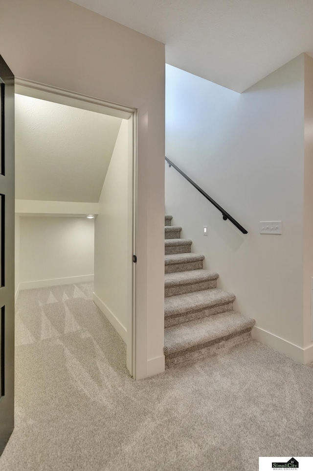 stairs with baseboards and carpet