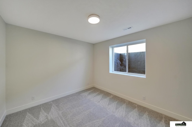unfurnished room with visible vents, carpet, and baseboards