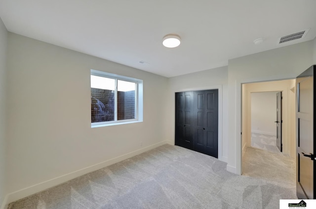 unfurnished bedroom featuring carpet flooring, visible vents, and baseboards