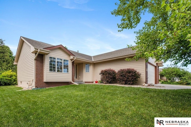 ranch-style home with an attached garage, a front yard, brick siding, and concrete driveway