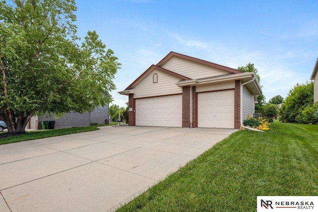 view of side of home featuring driveway, a lawn, brick siding, and a garage