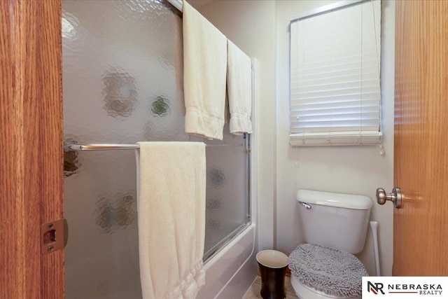 full bath featuring enclosed tub / shower combo and toilet