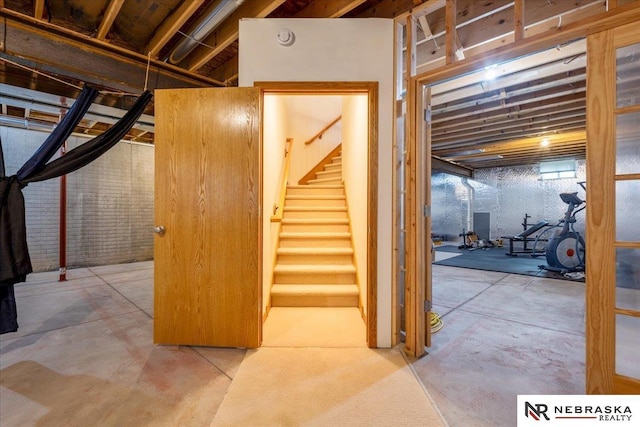 unfinished below grade area featuring stairway