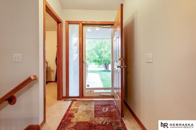 entryway featuring light tile patterned floors and baseboards