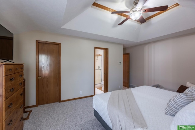 carpeted bedroom featuring a ceiling fan, ensuite bath, and lofted ceiling