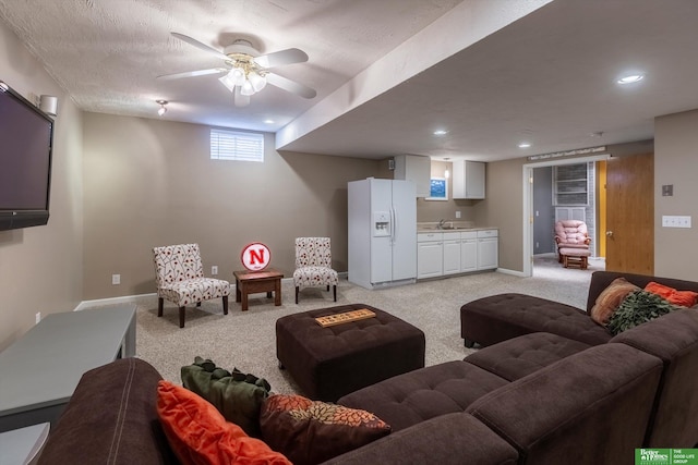 living area with baseboards, recessed lighting, light carpet, and ceiling fan