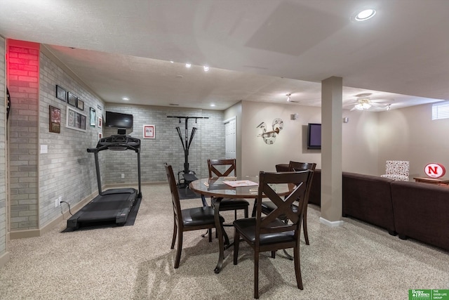 dining area featuring light colored carpet, baseboards, brick wall, recessed lighting, and a ceiling fan