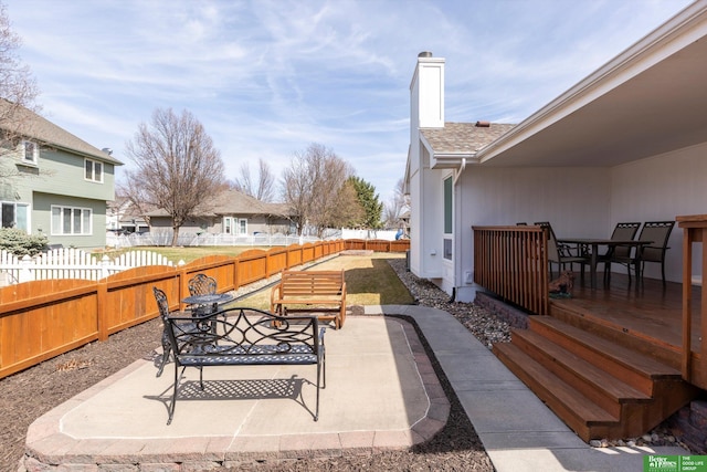 view of patio with outdoor dining area and a fenced backyard