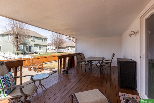 wooden terrace featuring outdoor dining area and fence