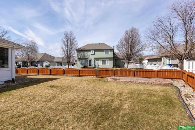view of yard featuring a fenced backyard and a residential view