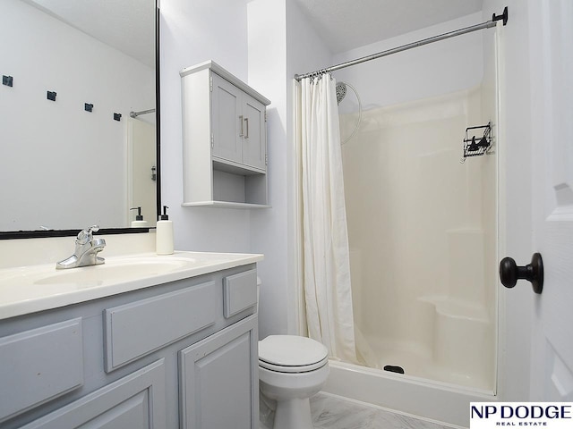 full bath featuring toilet, a stall shower, marble finish floor, and vanity