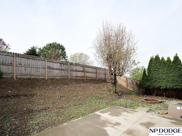 view of yard featuring an outdoor fire pit, a patio area, and a fenced backyard