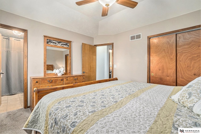 carpeted bedroom featuring a ceiling fan and visible vents