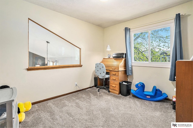 carpeted home office with baseboards