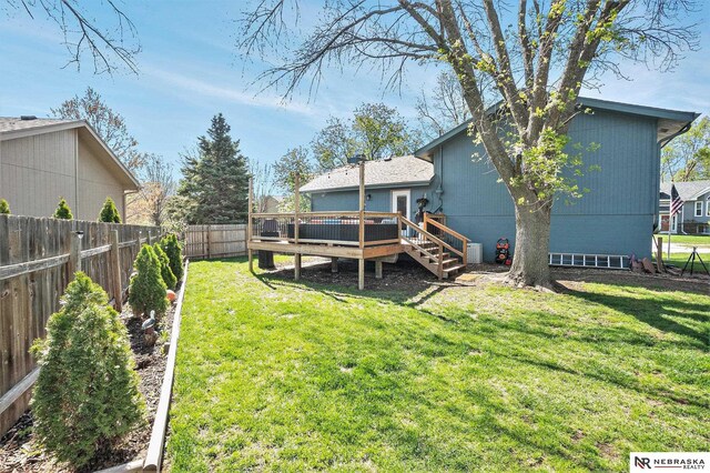 view of yard with a fenced backyard and a wooden deck