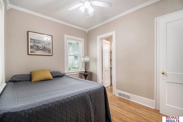 bedroom with baseboards, ornamental molding, light wood-type flooring, and visible vents