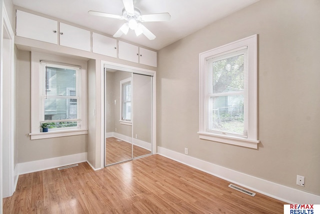 unfurnished bedroom with visible vents, light wood-style floors, baseboards, and multiple windows