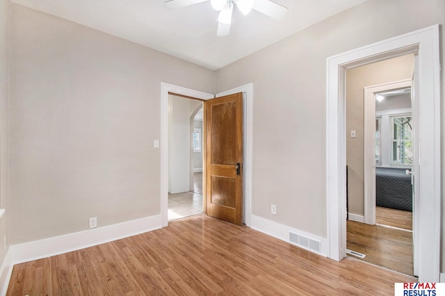 unfurnished bedroom featuring baseboards, visible vents, and light wood-style floors